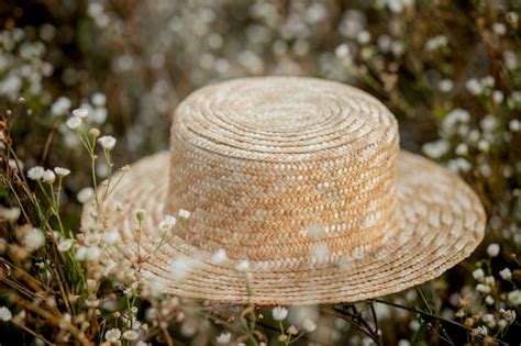 Premium Photo | Hat on wild white flowers.