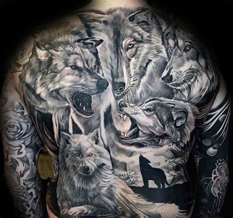 a man with tattoos on his back and some wolfs in the woods behind him