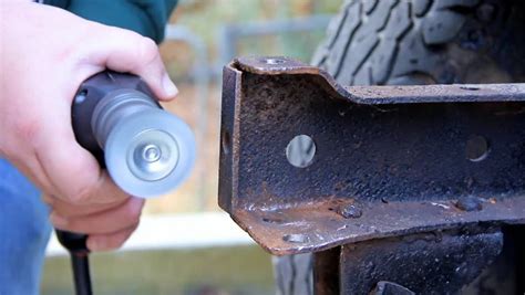 Wire Wheel Being Used To Clean Off Rust On An Older Vehicle Chassis ...