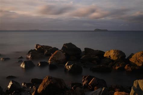 Premium Photo | Sunset on the beach seaside town of turgutreis and spectacular sunsets long exposure