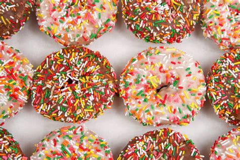 Close Up on Cake Donuts with Sprinkles, Chocolate and Vanilla Frosting ...