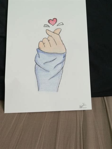 a drawing of a hand with a heart on it's finger holding up a blanket