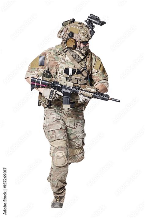 Elite member of US Army rangers in combat uniforms with his shirt sleeves rolled up, in helmet ...