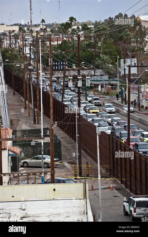 Border fence and backed up traffic crossing from Mexicali, Mexico Stock ...