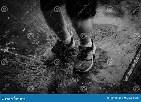 Splash from a Child Jumping in a Rain Puddle Stock Image - Image of splash, jumping: 126727133