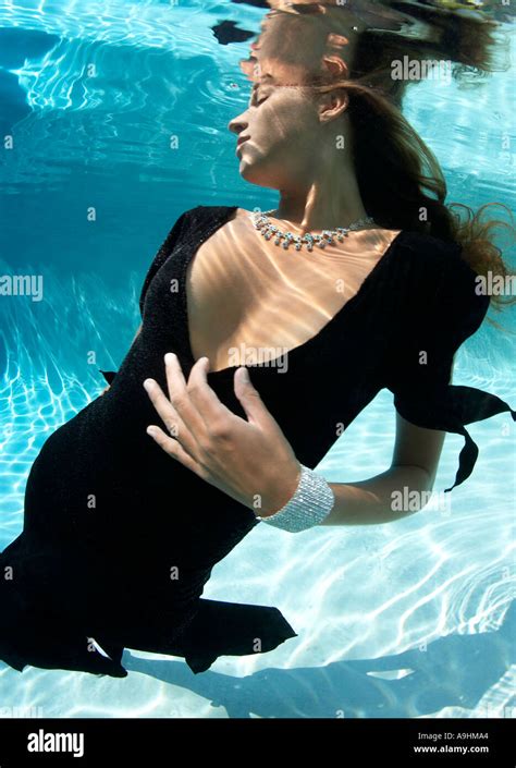 Woman in fashion clothing underwater in swimming pool Stock Photo - Alamy