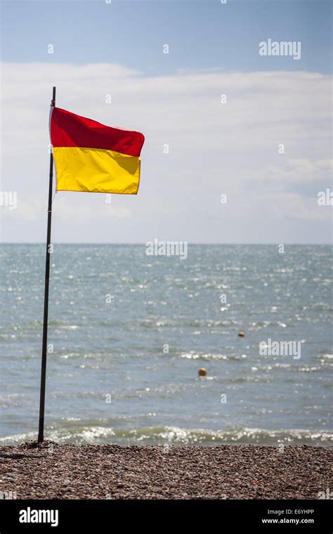 Lifeguard flag on the beach Stock Photo - Alamy