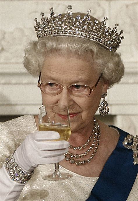 an older woman wearing a tiara and holding a wine glass