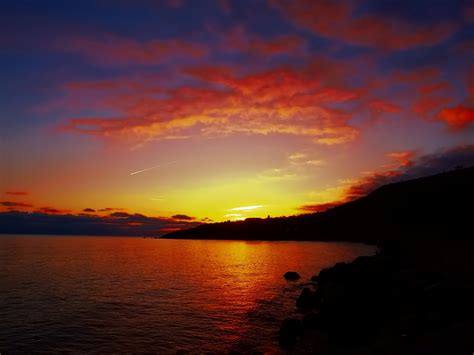 the orange and blue sky over the lake at sunset, orange and blue sunset ...