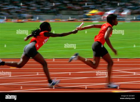 Track & Field. Runners In A Relay Race, Passing Baton Stock Photo - Alamy