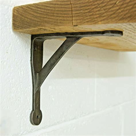 a wooden shelf with metal brackets on it