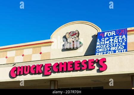 Chuck E. Cheese sign above the entrance to restaurant. Chuck E. Cheese is a chain of American ...