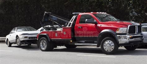 Red Tow Truck Hauling Away White Car Stock Photo - Image of automobile ...