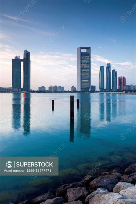 UAE, Abu Dhabi, skyline, Nations Towers, ADNOC Tower, Etihad Towers, dawn. - SuperStock