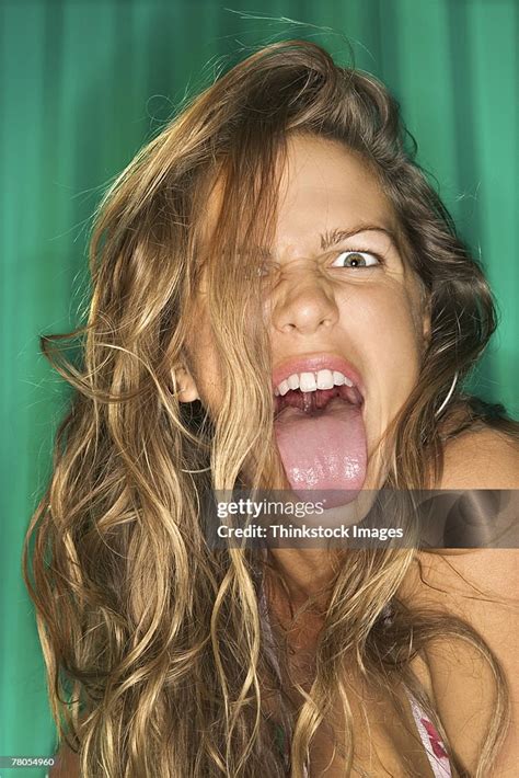 Woman Sticking Tongue Out High-Res Stock Photo - Getty Images