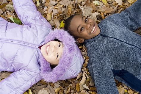 Smiling Children Lying On Autumn Leaves Photograph by Ian Boddy - Fine ...