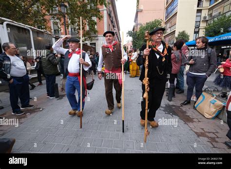 People dressed in traditional costumes walk through the Streets of Madrid during the festival of ...