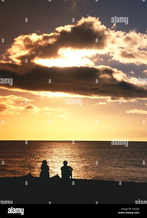 Couple on beach in sunset light Oahu Hawaii Stock Photo - Alamy