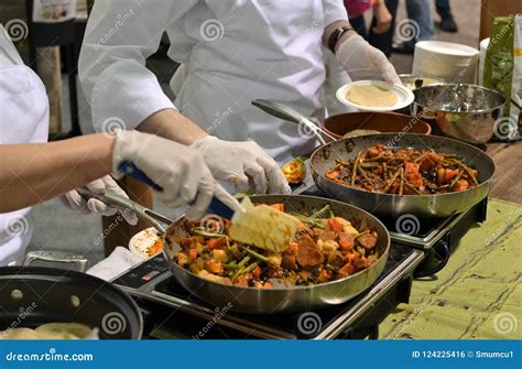 Two Chefs at a Natural Products Trade Show are Sampling Food and ...