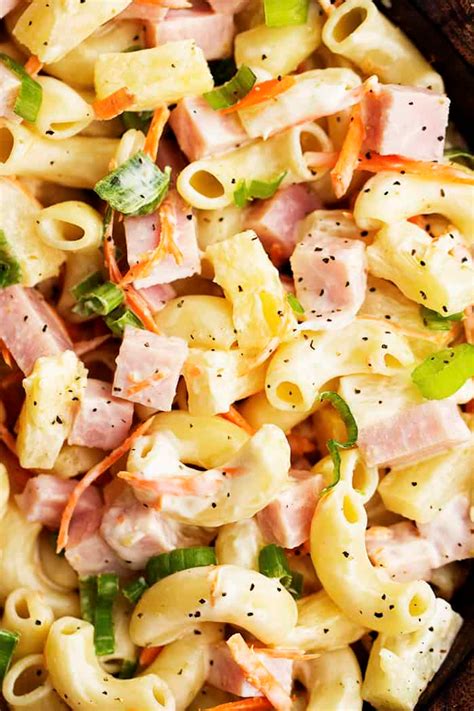 A delicious macaroni pasta salad with ham, pineapple, shredded carrots, and green onions. It has ...