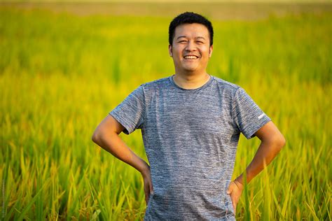 "Happy Asian Farmer Portrait In Rice Field" by Stocksy Contributor "Bo Bo" - Stocksy