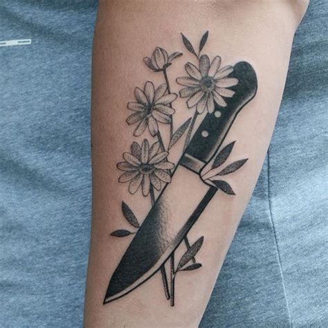 Knife and flowers tattoo on the forearm - Tattoogrid.net