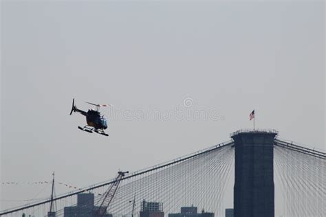 A Helicopter Flying Over the Brooklyn Bridge Stock Image - Image of ...