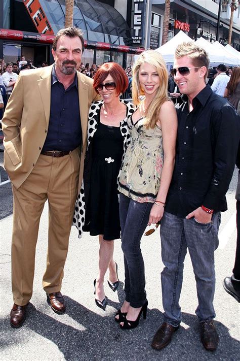 three people standing next to each other in front of a crowd at an outdoor event