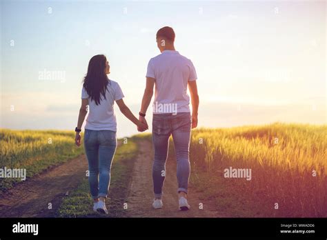 Couple Holding Hands Walking Away Stock Photo - Alamy