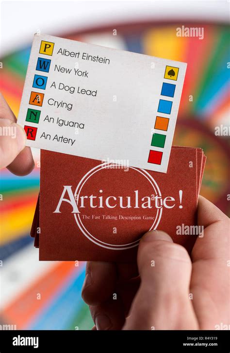 A teenage boy playing Articulate board game Stock Photo - Alamy