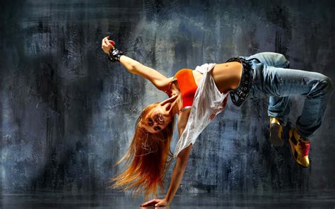 Download A Woman Is Doing A Dance On A Dark Background | Wallpapers.com