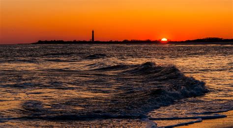 The Cape May Point Lighthouse at sunset by JonBilousPhotography