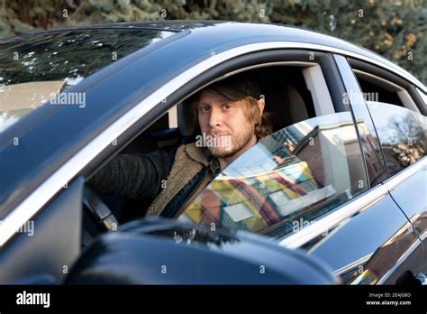 Man driving car seen through window Stock Photo - Alamy