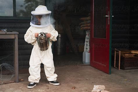 "Boy In Beekeeper Suit With Smoker" by Stocksy Contributor "Urs ...