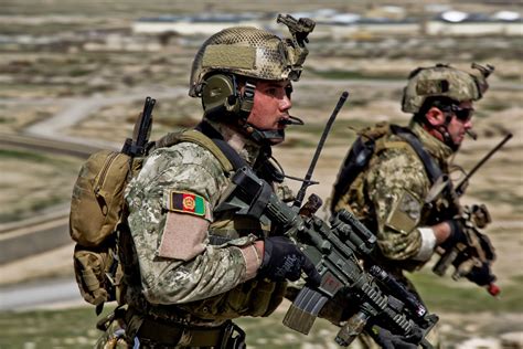 Afghan National Army Commandos running to a compound during a live training demonstration in ...