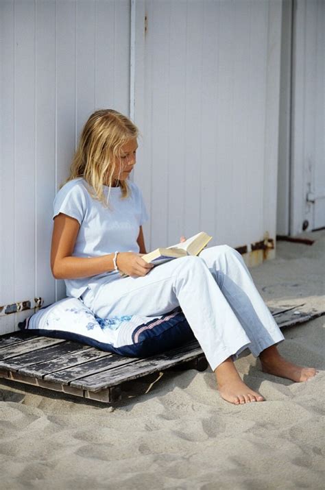 A girl reading a book on the beach – License image – 700967 Image Professionals