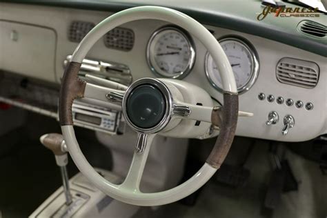 the interior of an old car with gauges and dashboard