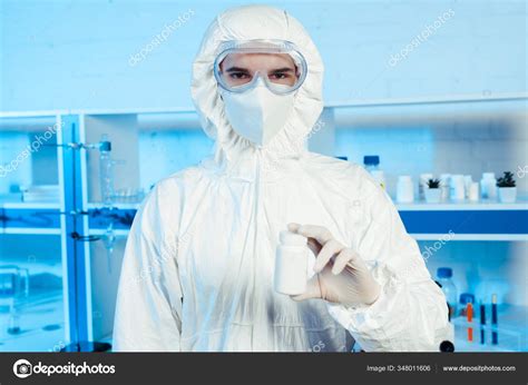 Scientist Hazmat Suit Goggles Holding Bottle Laboratory — Stock Photo © IgorVetushko #348011606