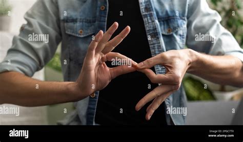 Sign language interpreter man translating a meeting to ASL, American Sign Language. Empty copy ...