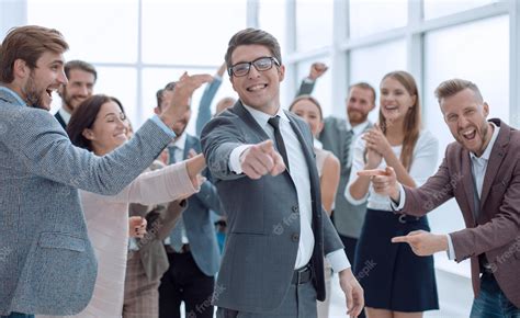 Premium Photo | Happy businessman standing in front of the business team and poi