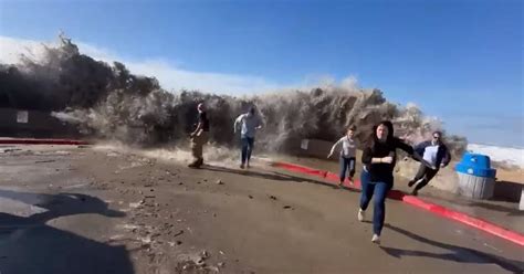 California: Rogue wave rips past Ventura seawall as beachgoers flee ...