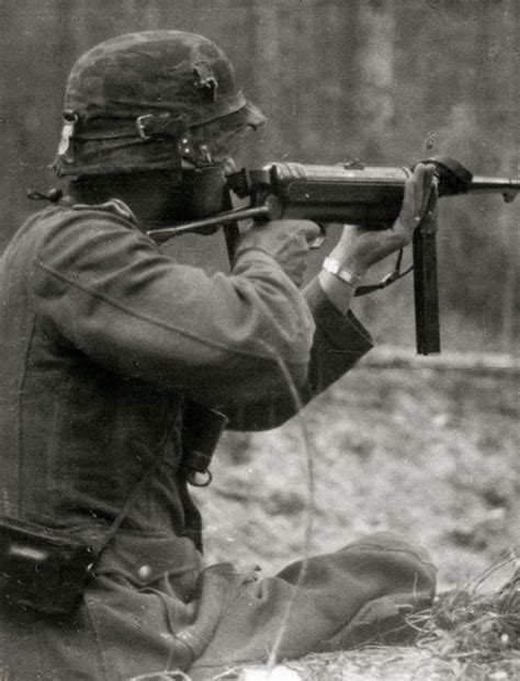 World War II History: A German infantryman aims his MP40 submachine gun ...