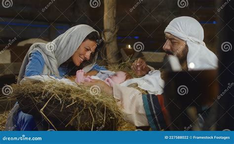 Mary and Joseph Speaking with Baby Jesus in Manger Stock Photo - Image ...