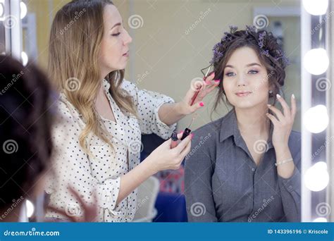 Stylist Makeup Artist Doing Makeup and Hair in a Beauty Salon. Professional Make-up. Stock Photo ...