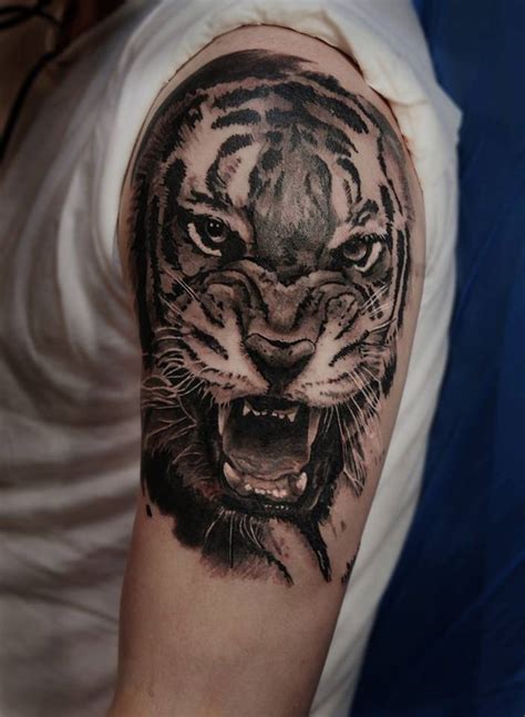 Realistic tiger tattoo on the left upper arm and