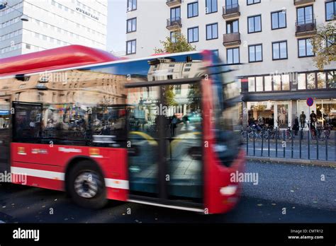 Bus driving in city Stock Photo - Alamy