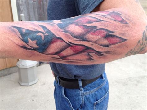 a man's arm with an american flag tattoo on it