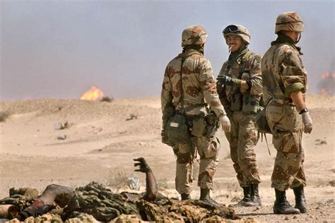 Gulf War 1.... U.S. soldiers speak near an Iraqi soldiers' corpses in ...