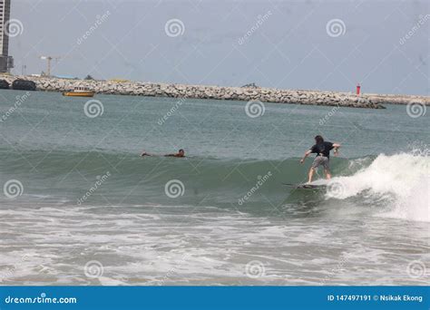 A Tourist is Enjoy Surfing in Lagos Beach, Admirers Look on Editorial ...