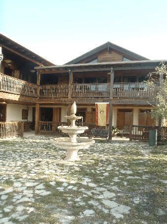 an outside view of a building with a fountain in the foreground and several balconies on the ...